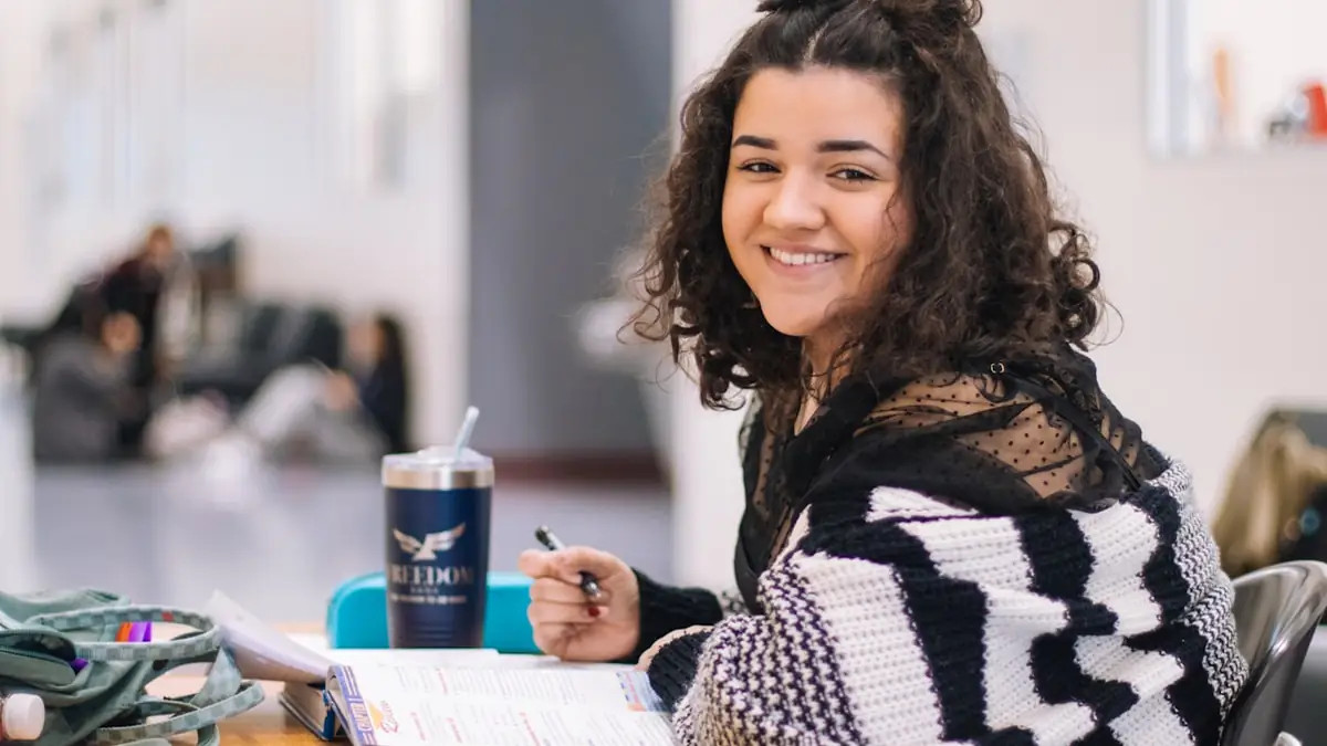 Student attending an interactive online tuition class on a laptop