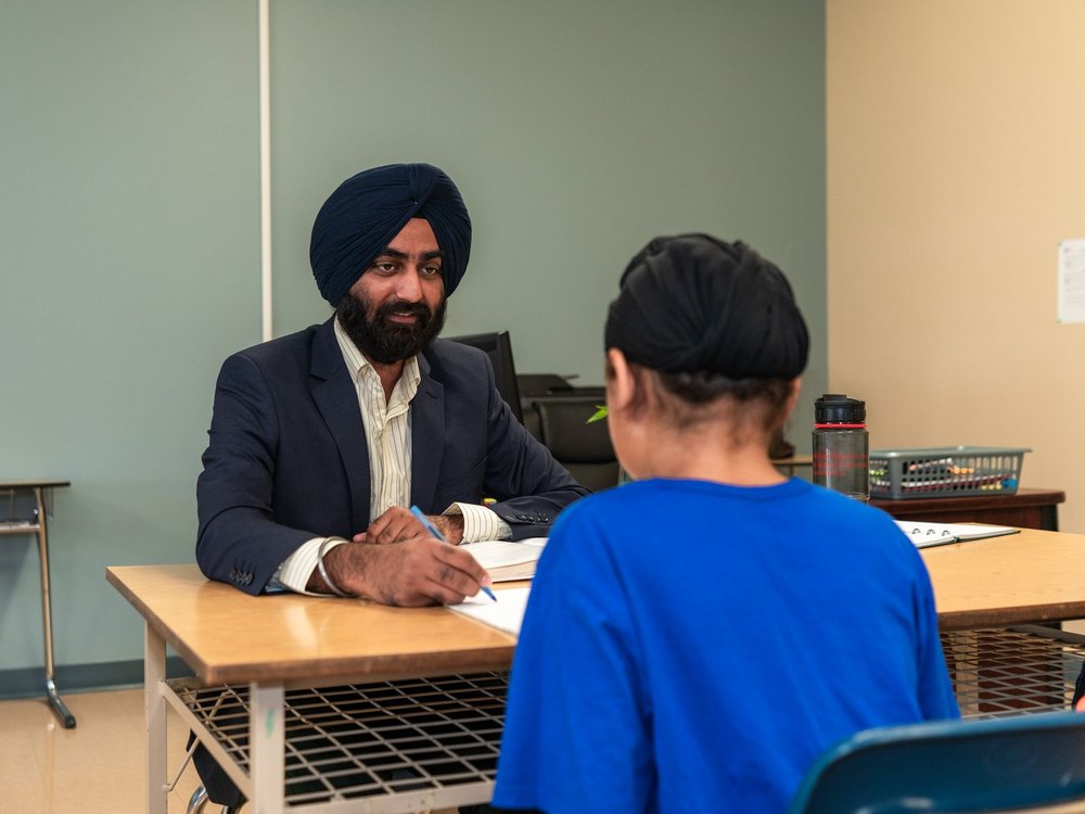 Students learning together with guidance from an experienced mentor